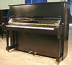 A Steinway Model V upright piano with a polished, black case A Steinway Model V upright piano with a black case