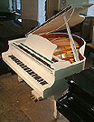 A brand new Halle & Voight baby grand piano with a white case and polyester finish. AA brand new Halle & Voight baby grand piano with a white case and polyester finish.