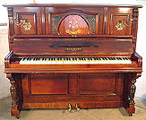 A Waldberg upright piano with a polished, rosewood case and inlaid detail in an art nouveau design. A Waldberg upright piano with a polished, rosewood case and inlaid detail in an art nouveau design.