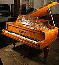 An antique Collard & Collard grand piano with a polished, satinwood case. An antique Collard & Collard grand piano with a polished, satinwood case.