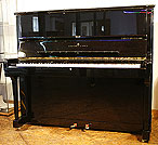 A preowned Steinway Model K upright piano with a black case and polyester finish. A preowned Steinway Model K upright piano with a black case and polyester finish.