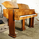 An Art-deco Strohmenger baby grand piano with a figured walnut case. An Art-deco Strohmenger baby grand piano with a figured walnut case.