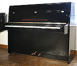A Steinway Model Z upright piano with a black case and polyester finish. A Steinway Model Z upright piano with a black case and polyester finish.