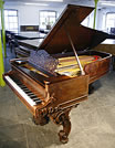 An antique, Steinway concert grand piano with a rosewood case and beautifully carved legs An antique, Steinway concert grand piano with a rosewood case and beautifully carved legs.