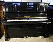A Bechstein upright piano with a polished, black case A Bechstein upright piano with a polished, black case