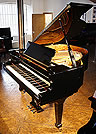 A Fazioli F156 grand piano with a black case and polyester finish. A Fazioli F156 grand piano with a black case and polyester finish.