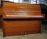 A Kemble upright piano with a mahogany case A Kemble upright piano with a black case and polyester finish.
