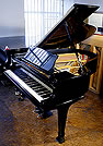A Steinway Model M grand piano with a black case. A Steinway Model M grand piano with a black case.