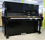 A Yamaha U3 upright piano with a black case and polyester finish. A Yamaha U3 upright piano with a black case and polyester finish.