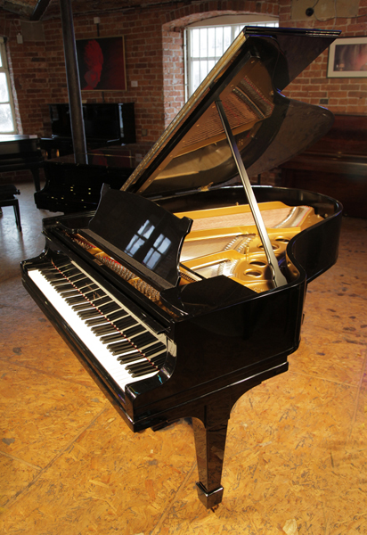 A 1923, Steinway Model O grand piano with a black case and spade legs. Piano has eighty-eight notes and a two pedal lyre 