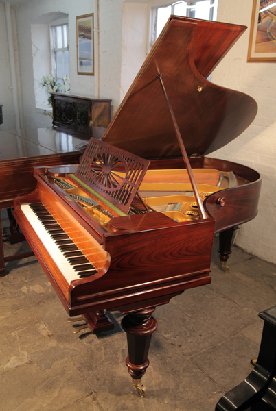 An antique, Bechstein Model A grand piano with a polished, rosewood case and turned legs. Piano has eighty-five notes and a two pedal lyre