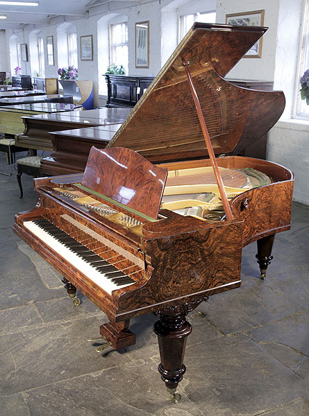 An 1882, Bechstein Model V grand piano for sale with a book matched, burr walnut case and turned legs.