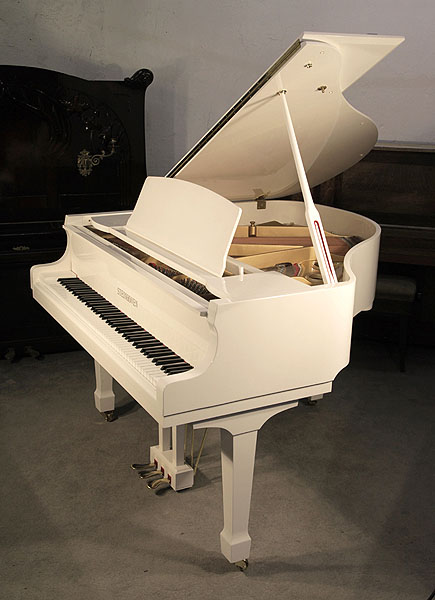 A nearly new, Steinhoven Model 148 baby grand piano with a white case and spade legs