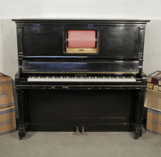 A 1922, Steinway Welte pianola with a polished, black case. Comes with over 70 rolls. Piano has an eighty-eight note keyboard and two pedals.