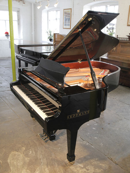 A Brodmann BG187 grand piano for sale with a black case and spade legs