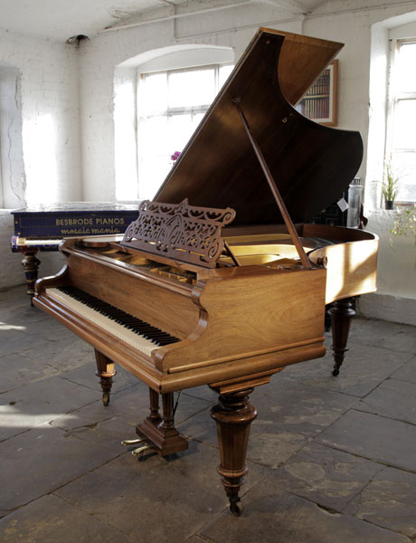 A 1900, Bechstein Model V grand piano for sale with a walnut case and turned legs. Piano has an eighty-eight note keyboard and a two-pedal lyre. 