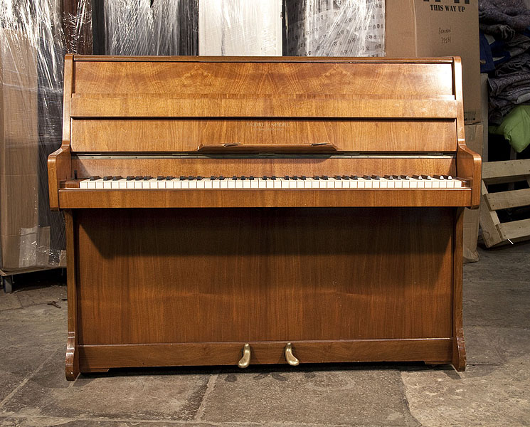 A Moore and Moore Upright Piano For Sale with a Walnut Case and Brass Fittings. Piano has an eighty-five note keyboard and two pedals
