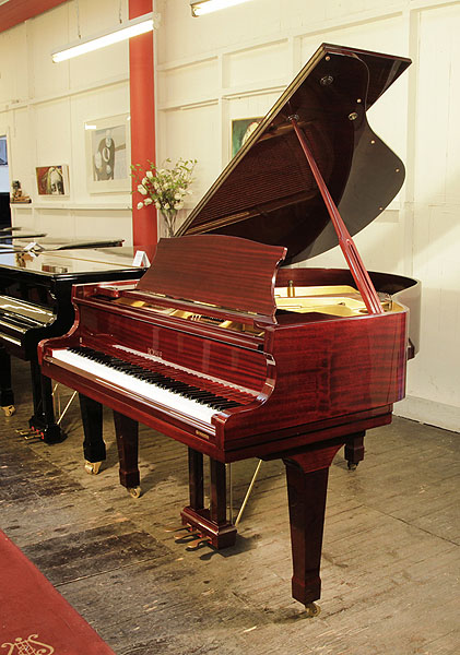 A Royale DG-1 baby grand piano with a mahogany case and polyester finish