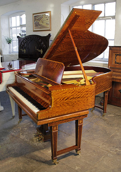 Stunning, 1906 Steinway Model O grand piano with a polished, satinwood case and gate legs. Entire cabinet inlaid with boxwood stringing and crossbanding accents. Piano has an eighty-eight note keyboard and a two-pedal lyre. 