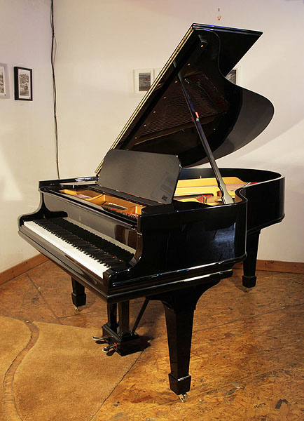 A rebuilt, 1909, Steinway Model O grand piano with a black case and spade legs. Piano has an eighty-eight note keyboard and a two-pedal lyre.  