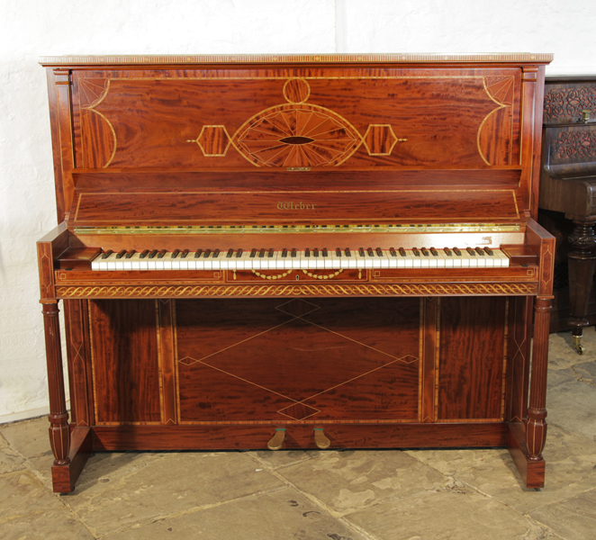 A 1912, Weber upright piano for sale with a flame mahogany case and turned, fluted legs. Cabinet inlaid with a stylised, Neoclassical design featuring geometric forms in a variety of woods.  Piano has an eighty-eight keyboard and two pedals.