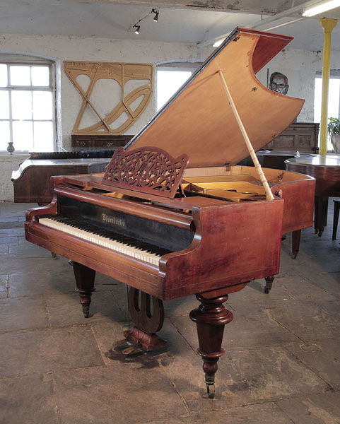 An 1879, Bosendorfer grand piano for sale with a filigree music desk, mahogany case and turned legs