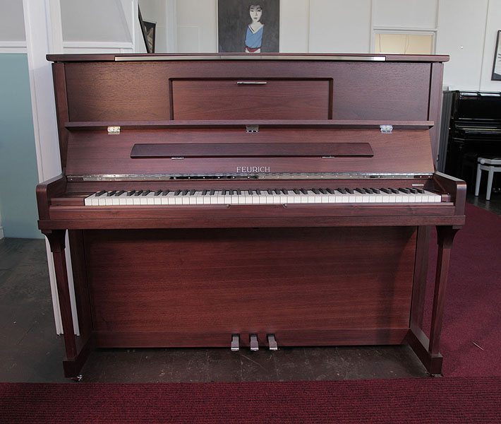  Brand New Feurich Model 123 upright piano with a satin, walnut case, LED Lighting and chrome fittings. Piano features a high speed KAMM action that allows for extremely fast repetition 