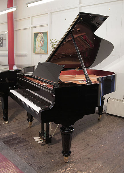 A 2021, Toyama TC-187 grand piano for sale with a black case and turned, faceted legs. Piano has an eighty-eight note keyboard and a three-pedal lyre.