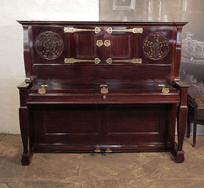 Arts and Crafts, 1897, Bechstein upright piano with a  rosewood case, fretwork panels and ornate brass hinges. Designed by Walter Cave. Piano has an eighty-eight note keyboard and two pedals. 