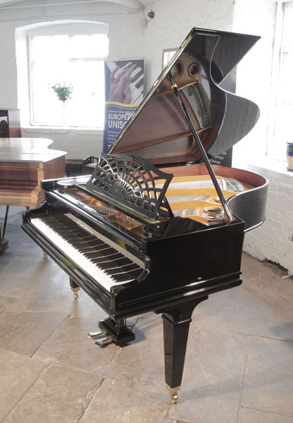 Restored, 1924, Bechstein Model A1 grand piano with a black case. The music desk is in an openwork sunset design. Piano hassquare, tapered legs. Piano has an eighty-five note keyboard and a two-pedal lyre.