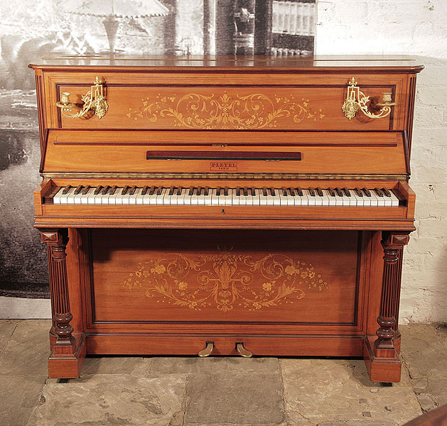 An 1893, Pleyel upright piano with a satinwood case. brass candlesicks and fluted, column legs. Entire cabinet features intricate, Neoclassical style inlay.  Piano has an eighty-five note keyboard and two pedals