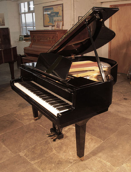 Reconditioned, 1973, Yamaha G1 baby grand piano for sale with a black case and square, tapered legs Piano has an eighty-eight note keyboard and a two-pedal lyre.  