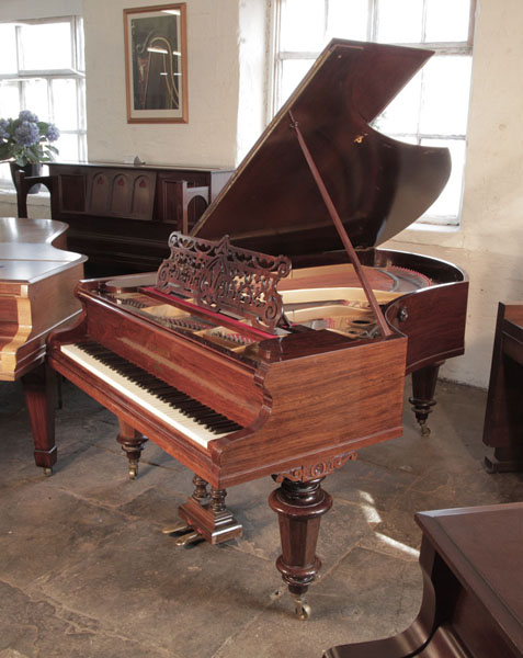 Antique, Bechstein model V grand piano for sale with a rosewood case and turned, faceted legs.  Piano has an eighty-eight note keyboard and a two-pedal lyre. 