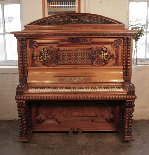 German Late Renaissance style, 1896, Pfaffe upright piano for sale with a walnut case and burr walnut panels.  Entire cabinet covered with ornate carvings of anthemions, shells, acanthus, strapwork, foliage and flowers in high relief. Piano exibited in the German Industrial and Art Fair in Berlin 1896. Piano has an eighty-five note keyboard and two pedals.