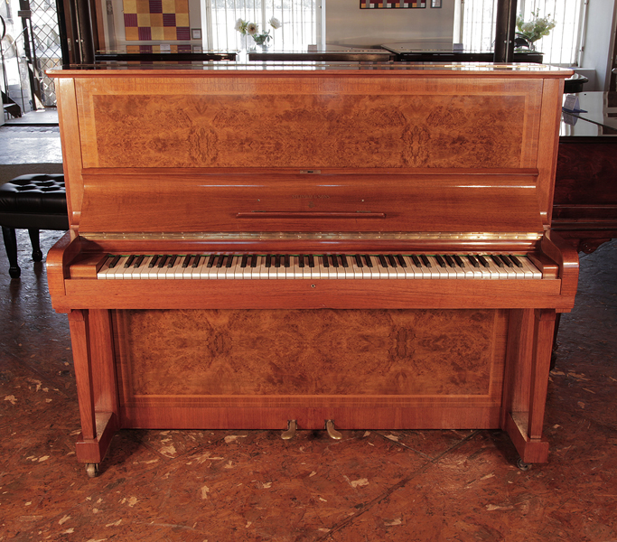 Reconditioned, 1939, Steinway Model V upright piano for sale with a walnut case and brass fittings. Piano features mirrored, burr walnut panels. Piano has an eighty-eight note keyboard and two pedals. 