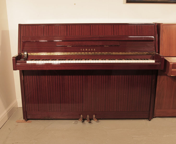 Reconditioned, 1988, Yamaha M108 upright piano with a mahogany case and brass fittings. Piano has an eighty-eight note keyboard and three pedals. 