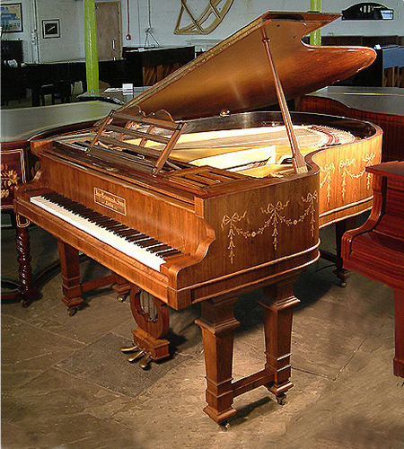 John Brinsmead and Sons grand piano with a polished rosewood case inlaid with Adams styl, swags and bows