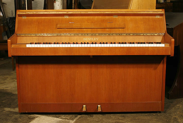Bentley Upright piano for sale with a walnut case Modern upright piano.Specialist piano dealer trader and wholesaler. Besbrode Pianos Leeds Yorkshire England UK