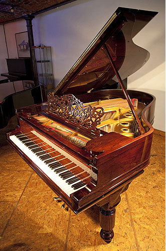An antique, 1900 Steinway Model A grand piano with a rosewood case, filigree music desk and elephant legs
