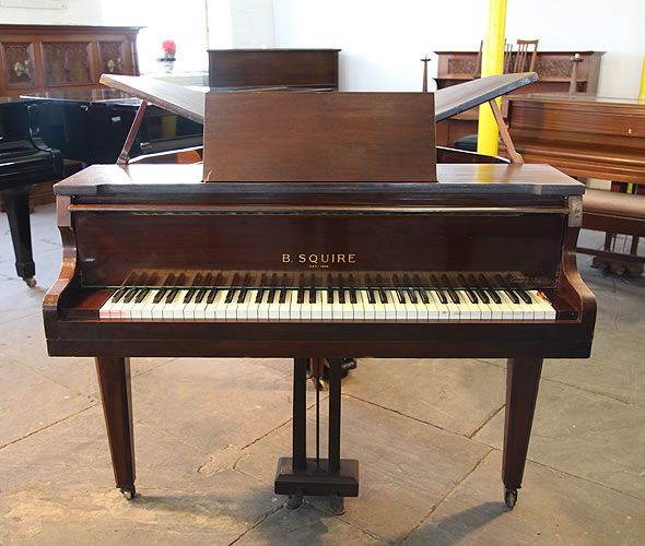 A 1939, Squire butterfly baby grand piano with a mahogany case. Piano has an seventy-three note keyboard and a two-pedal piano lyre.