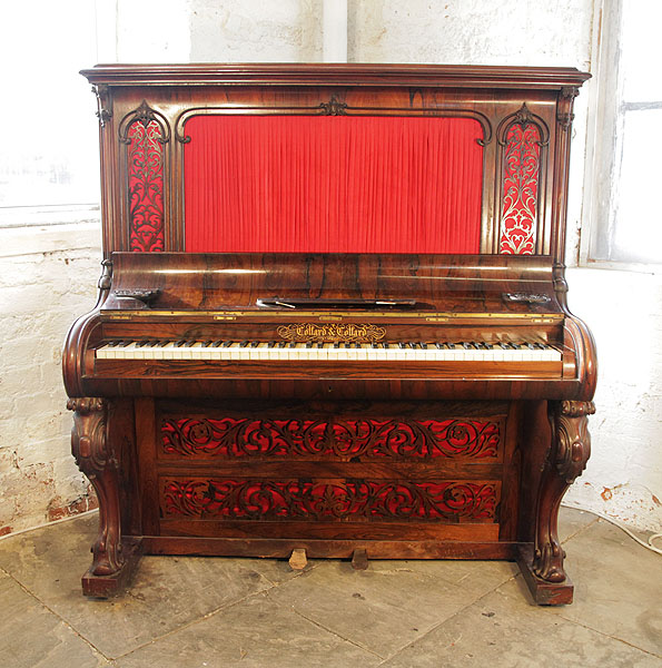 A Collard and Collard upright piano with a rosewood case. Cabinet features ornate, filigree panels with red silk backing and carved, cabriole legs