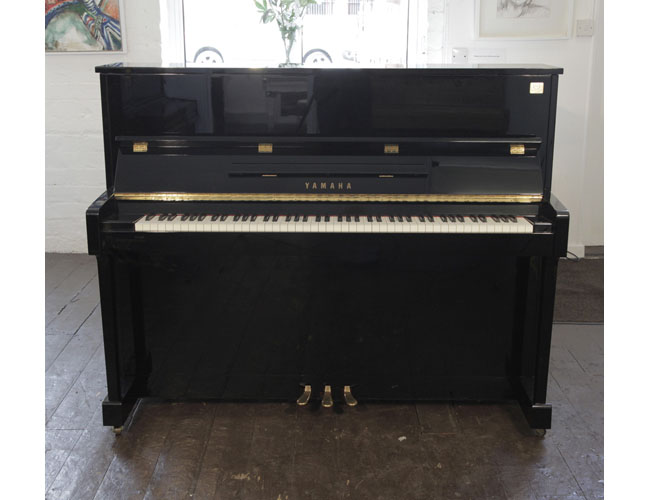 Reconditioned,  Yamaha ET121 upright piano for sale with a black case and brass fittings