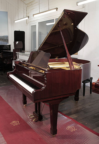 A 1993, Yamaha grand piano with a mahogany case and spade legs