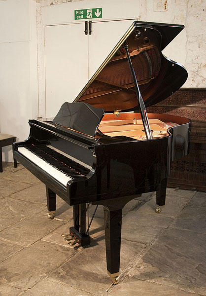 A 2013, Yamaha GB1 baby grand piano for sale with a black case and square, tapered legs. Piano lid has a slow fall mechanism. Piano has an eighty-eight note keyboard and a three-pedal lyre.