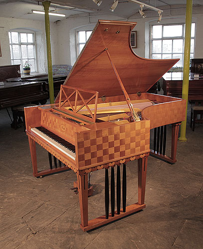 Restored, 1907 Ibach Model 2 grand piano with a cherry case in a checkerboard design and inlaid, contrasting squares on the piano lid.  Piano has square, gate legs with four contrasting black spindles. Piano one of two designed for and offered to Richard Strauss. Piano has an eighty-eight note keyboard and a two-pedal lyre.
