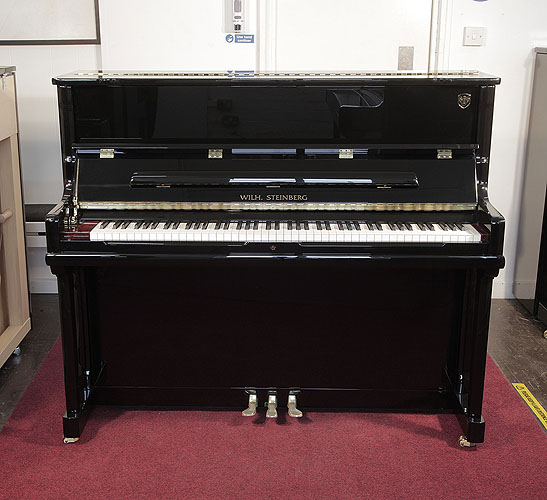 Piano for sale. Brand new, Wilh. Steinberg Model AT-K23 upright piano with a black case and brass fittings. Piano lid features a slow fall mechanism. Piano has an eighty-eight note keyboard and three pedals. 