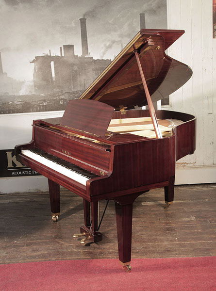 Reconditioned, 1974, Yamaha G1 baby grand piano for sale with a mahogany case and square, tapered legs Piano has an eighty-eight note keyboard and a two-pedal lyre.  