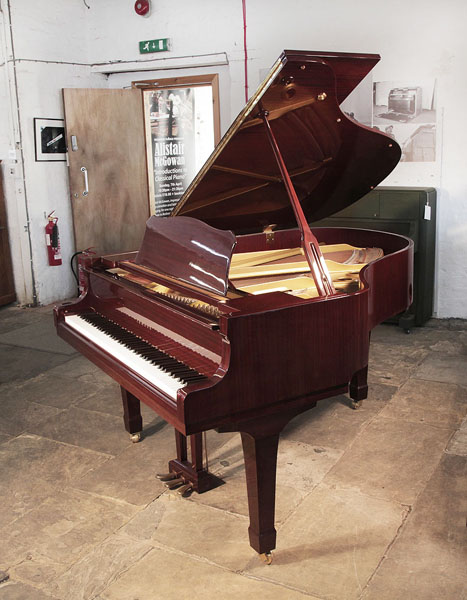 Reconditioned, 1993, Yamaha G2 grand piano with a mahogany case and spade legs. Piano has an eighty-eight note keyboard and a three-pedal lyre.  