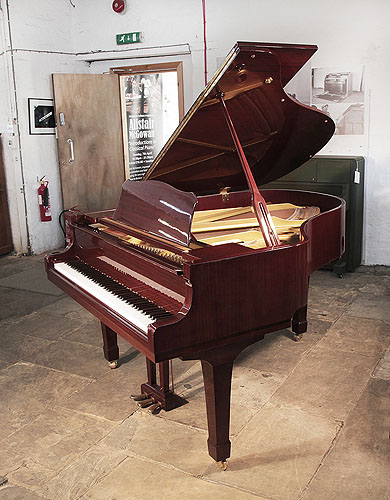 Reconditioned, 1993, Yamaha G2 grand piano with a mahogany case and spade legs. Piano has an eighty-eight note keyboard and a three-pedal lyre. 