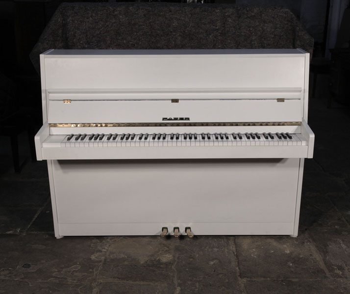 Pre-owned, 1979, Fazer   upright piano with a matt, white case and brass fittings. Piano has an eighty-eight note keyboard and three pedals.  